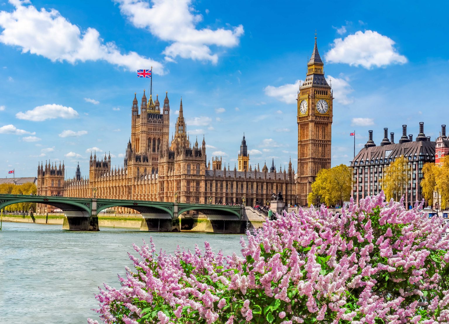 view of the houses of parliament from the river thames on a beautiful sunny day in london