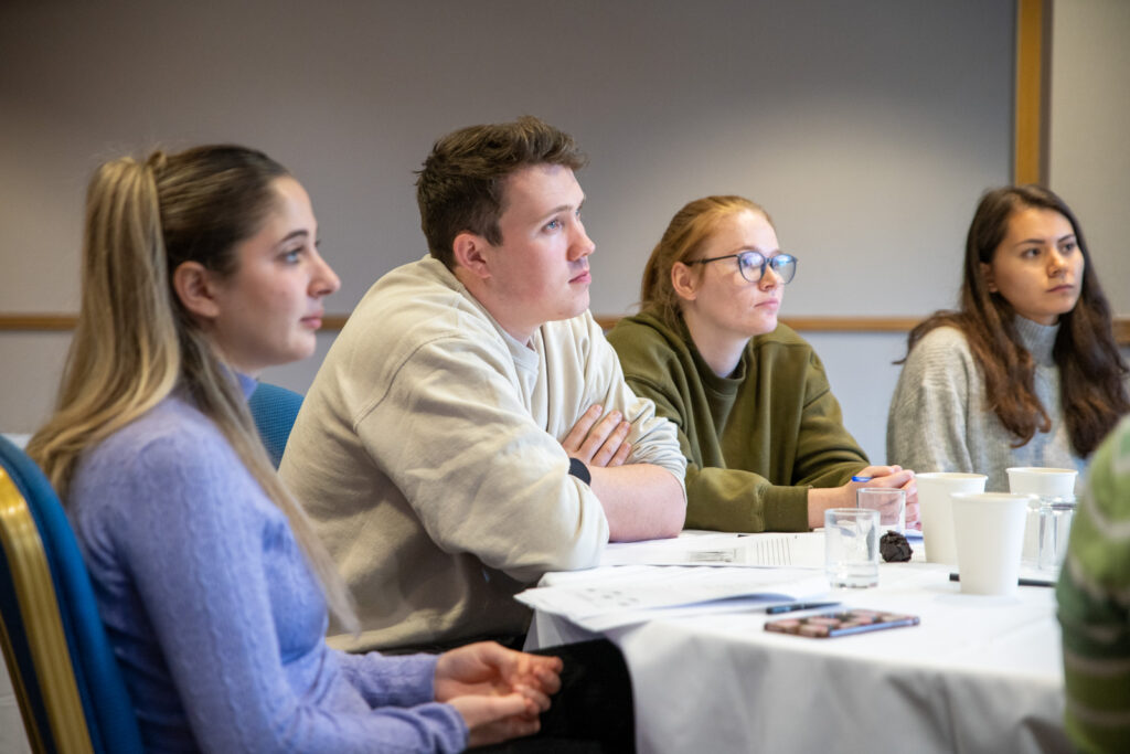 new graduates sat a table learning